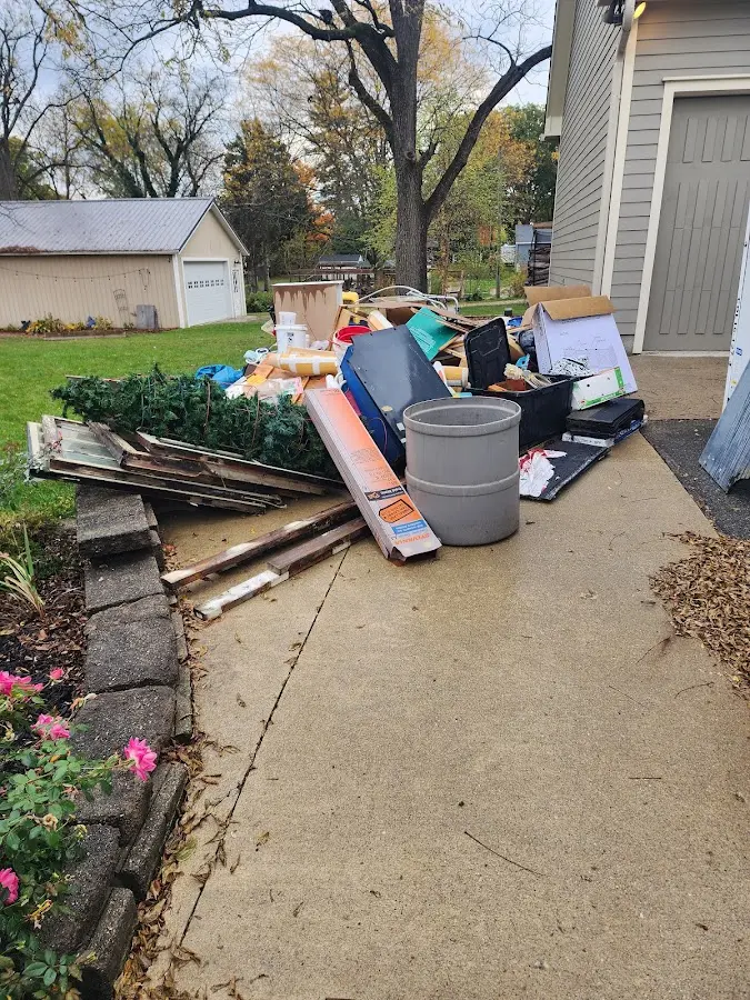 Dumpster being loaded with debris for Estate Cleanout Dumpster Rental in Panthersville